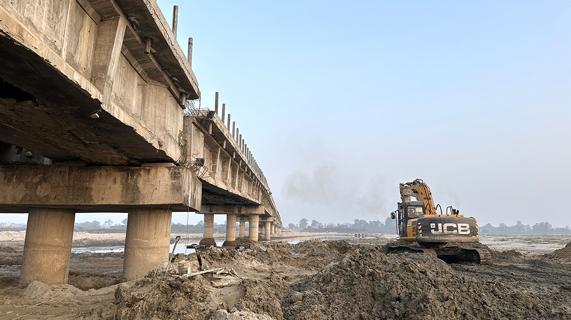 धनुषा–सिरहा जोड्न कमला नदीमा करिब १३ वर्षदेखि निर्माणाधीन रहेको पुलको पुनर्निर्माण कार्य गरिँदै। पुल निर्माण सम्पन्न चरणमा रहेकै बेला विसं २०७८ असारमा  नदीमा आएको बाढीका कारण पुलको दुई वटा पिल्लर भासिएकोमा अहिले मर्मत कार्यलाई तीव्रता दिइएको छ। हुलाकी राजमार्गकाे मेरूदण्डकाे रूपमा रहेकाे पुल लामाे समय निर्माण सम्पन्र नहुँदा नागरिकले सास्ती भाेग्नुपरेकाे छ। तस्बिरः विष्णु नेपाल/रासस