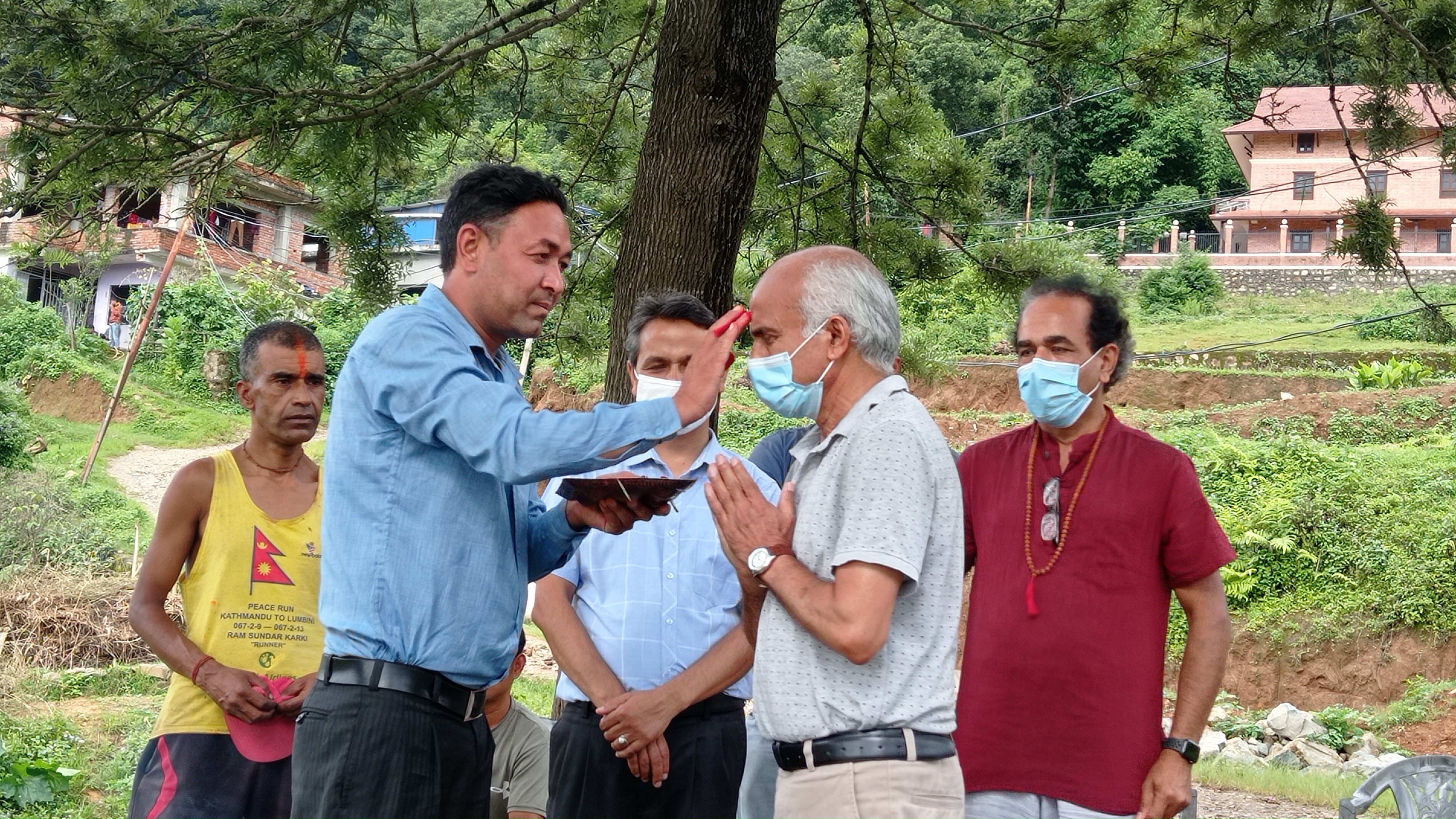 दलित समुदायका पुजारी लक्ष्मण रम्तेलको हातबाट टीका लगाउँदै डाक्टर गोविन्द केसी। तस्बिर: सबिना श्रेष्ठ/सेतोपाटी